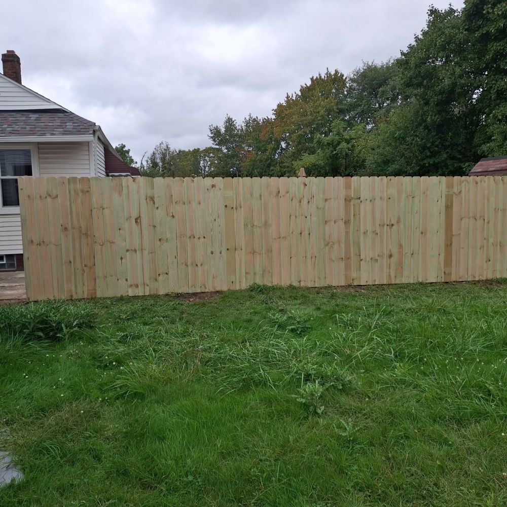 Wood privacy fence across a backyard