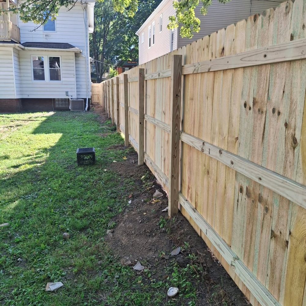 Wood privacy fence running down a side yard